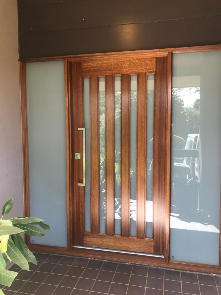 After - Large Wooden door replacement with vertical glass inserts