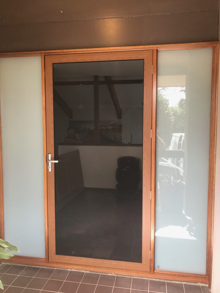 After - Large Wooden door replacement with vertical glass inserts and security screens open