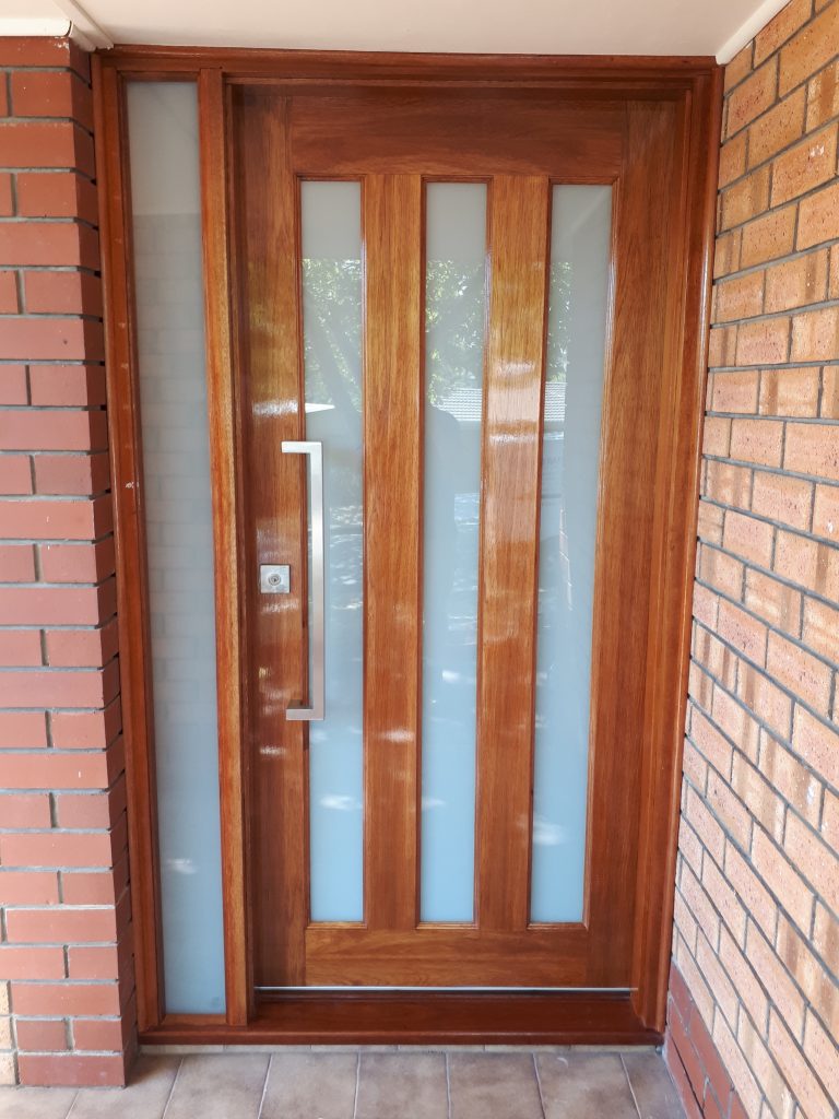 After - Security door replacement with wooden and glass inserts